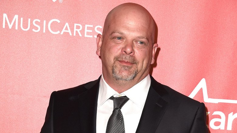 Rick Harrison posing while wearing a suit and tie