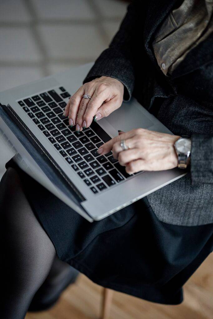 Office Administration Best Practices for Small Businesses in Nigeria 140 Hands typing on a laptop during digital office recordkeeping