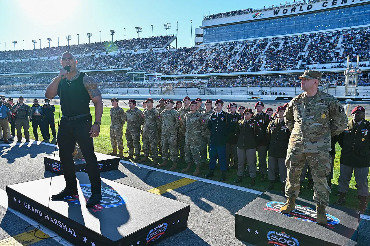 Open the featured image for Dwayne Johnson Disney Legend 2026: D23 Honors His Disney Journey Dwayne Johnson speaking at the 2024 Daytona 500