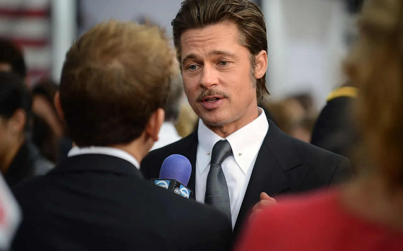 Brad Pitt speaking with press at a film premiere