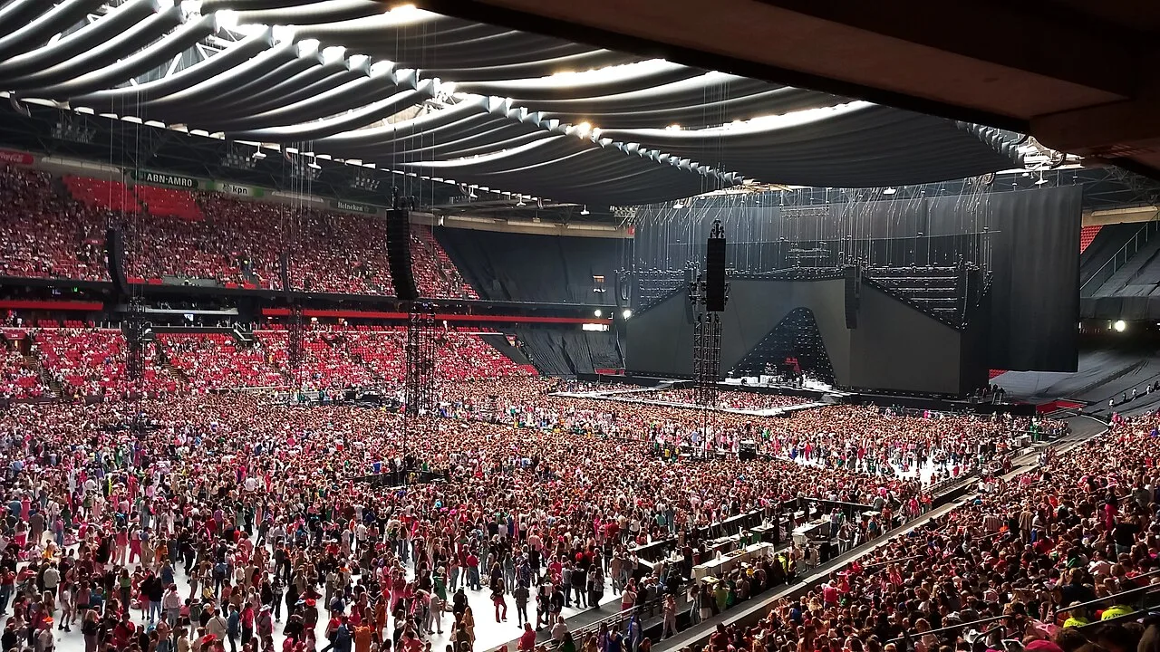 Open the featured image for Harry Styles Net Worth: What the £235 Million 2026 Estimate Really Tells Us Harry Styles performing at Johan Cruijff ArenA in 2023