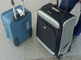 Travel luggage lined up inside an airport terminal