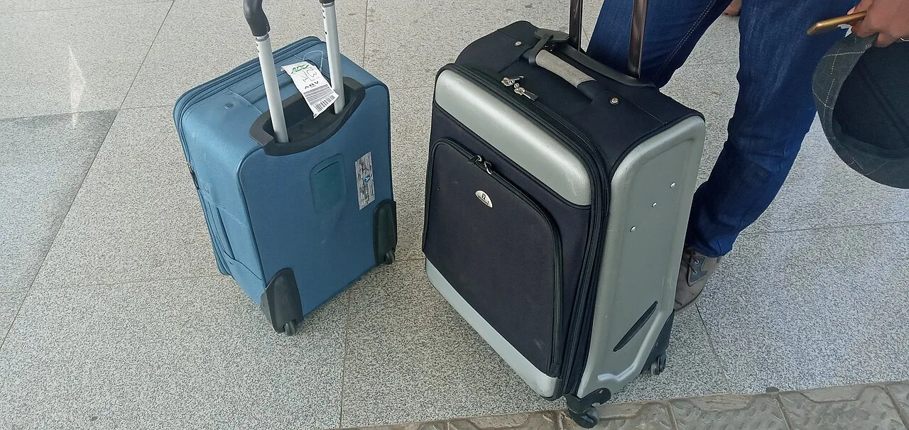Open the featured image for Labor Day Travel 2026: When to Drive and How to Cut Holiday Costs Travel luggage lined up inside an airport terminal
