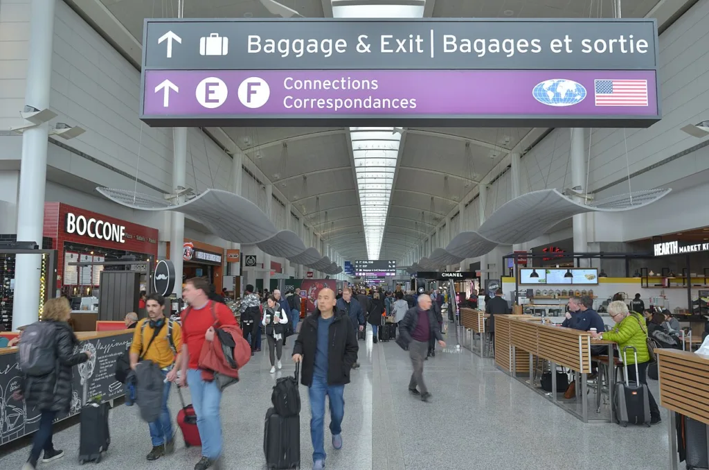 Travelers with luggage inside Toronto Pearson Airport Terminal 1