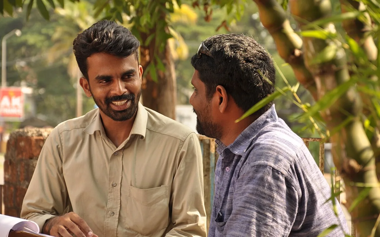 Filmmakers discussing a movie project designed around smartphone production