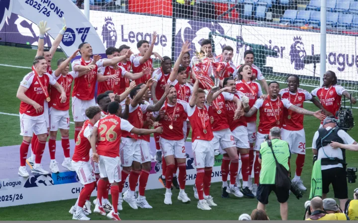 Arsenal players lift the Premier League trophy in May 2026