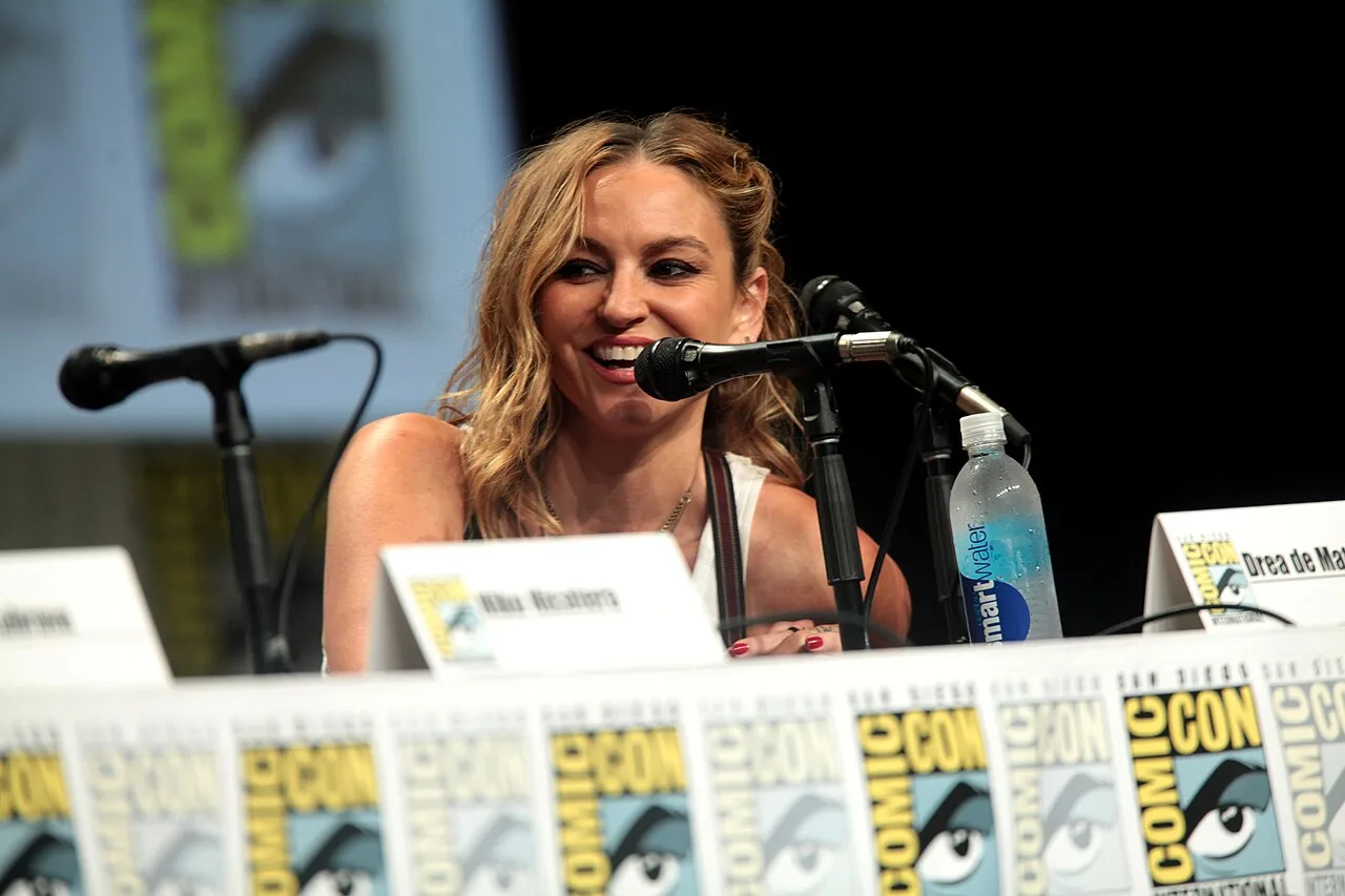 Open the featured image for Drea de Matteo OnlyFans Comeback Reframed Her Career After Hollywood Work Dried Up Drea de Matteo speaking at San Diego Comic-Con, illustrating her television career before her OnlyFans comeback