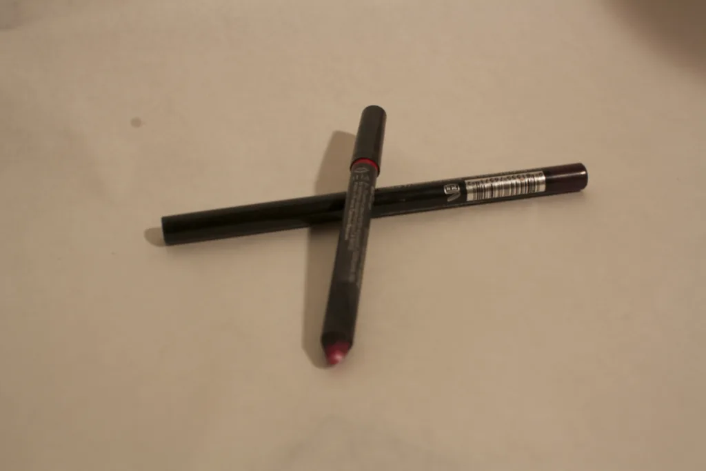 Red and dark lip liner pencils illustrating defined lip color for fall 2026