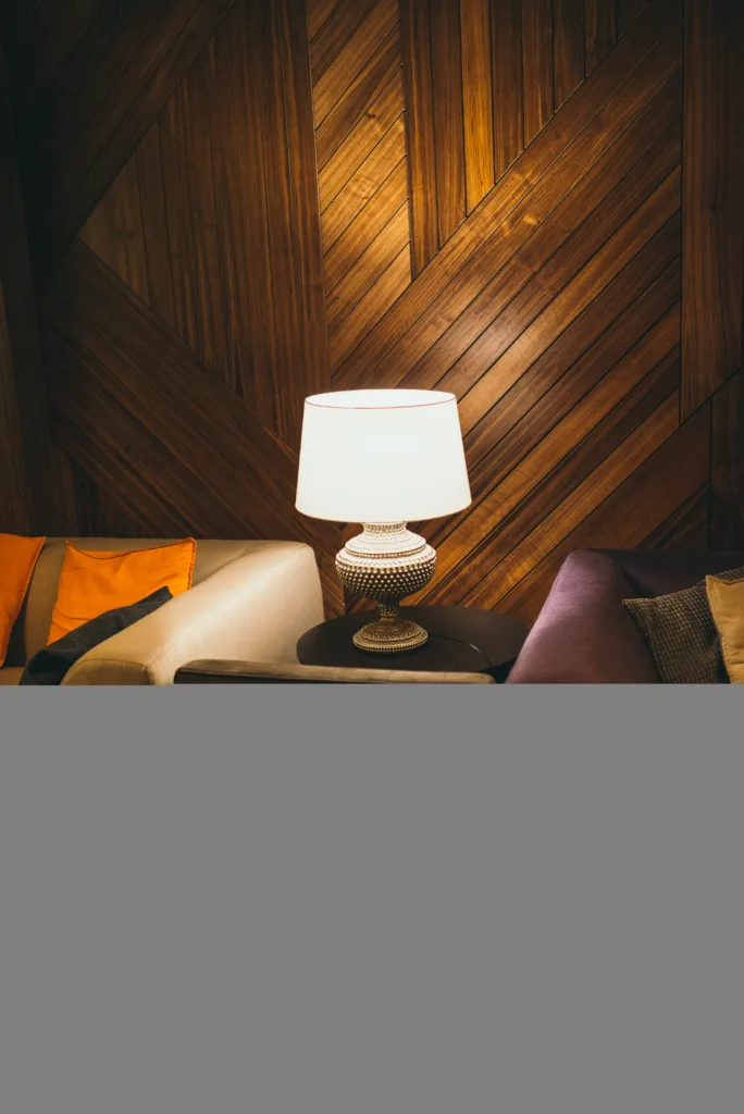 Cozy interior with a table lamp casting warm light beside sofas