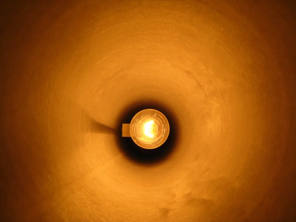 Warm glowing lamp illustrating layered interior lighting