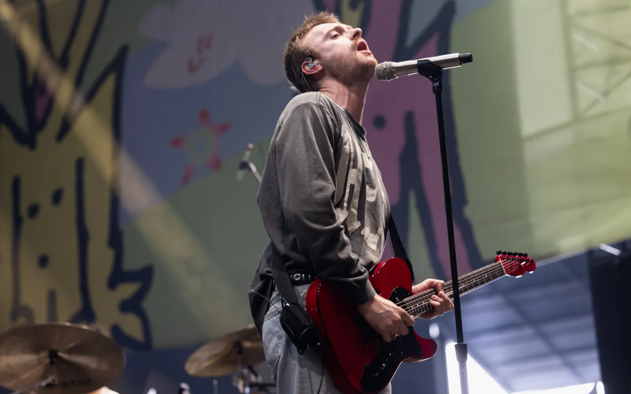 Finneas performing onstage during a live music festival appearance