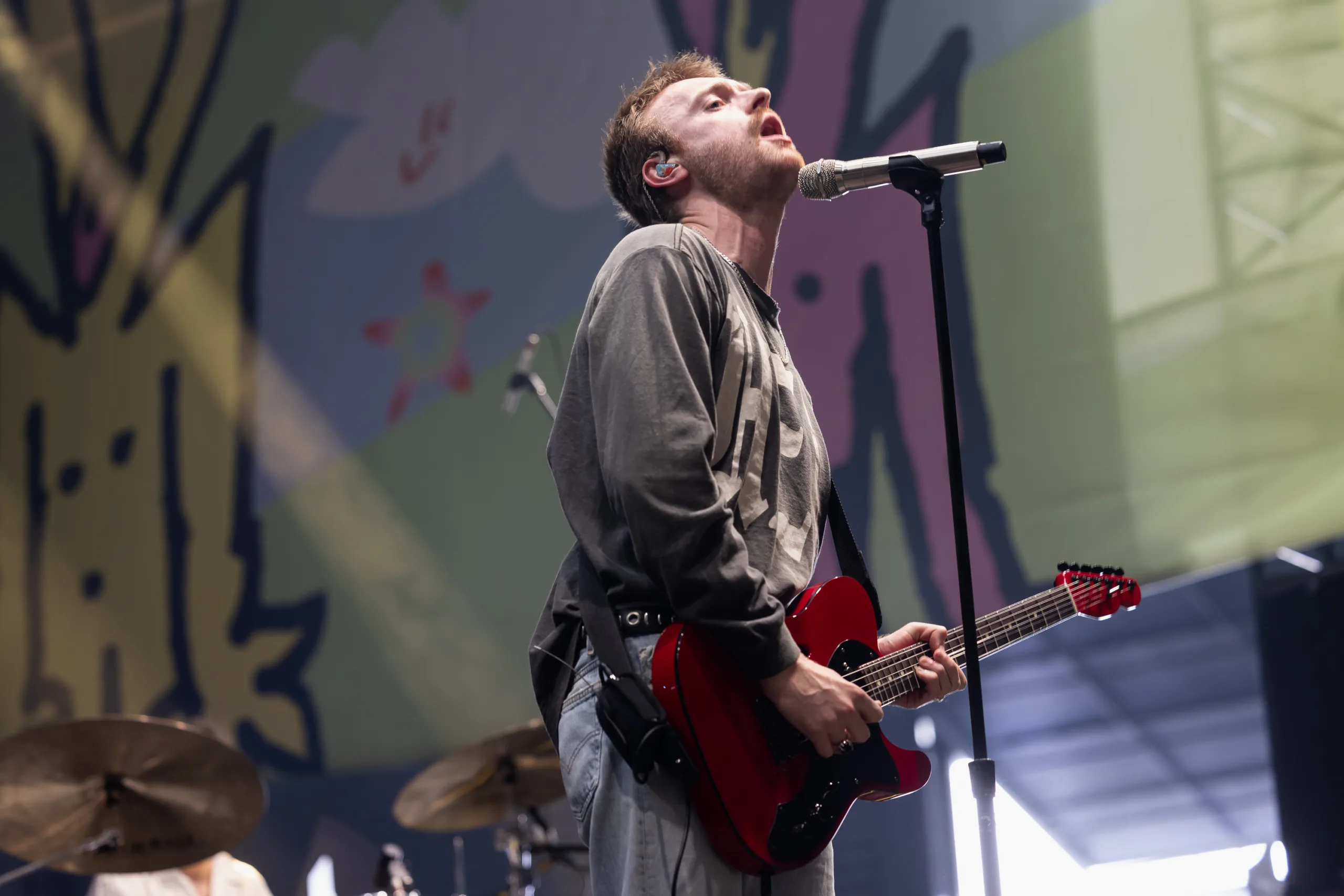 Finneas performing onstage during a live music festival appearance