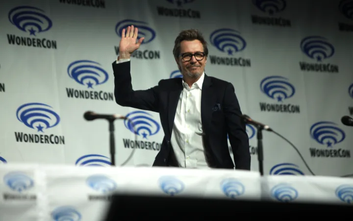 Gary Oldman waving at a WonderCon panel in Anaheim in 2014