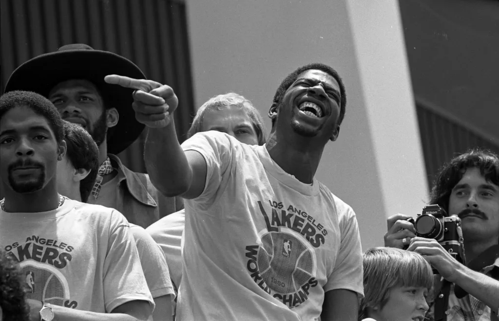 Magic Johnson celebrating with the Los Angeles Lakers at a championship rally in 1980