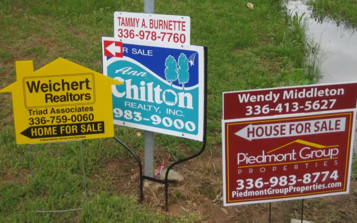 Multiple houses for sale signs illustrating the U.S. homebuying market
