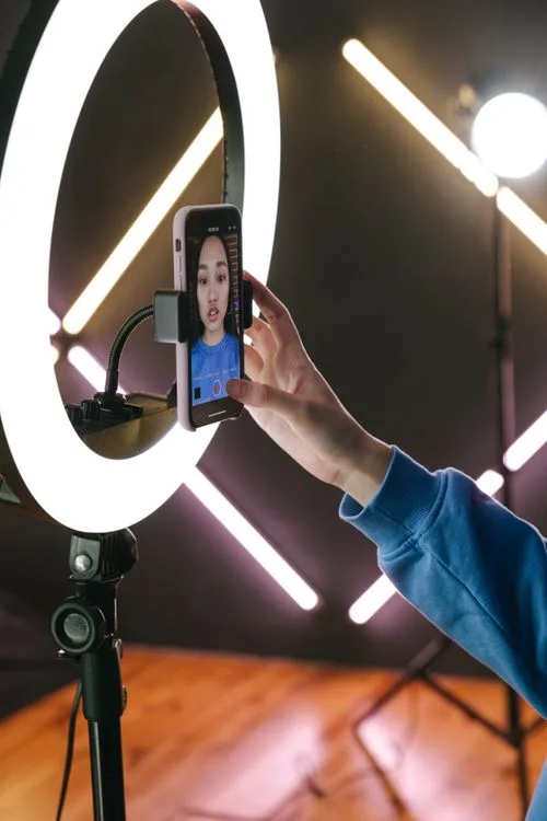 Content creator recording video with a smartphone and ring light, illustrating social video production for FAST channels