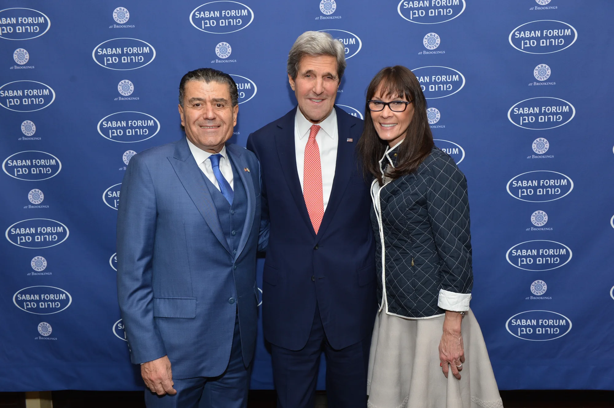 Open the featured image for Haim Saban Net Worth 2026: How Power Rangers Built a $3.3 Billion Fortune Haim Saban with John Kerry and Alisa Rubin at the Saban Forum