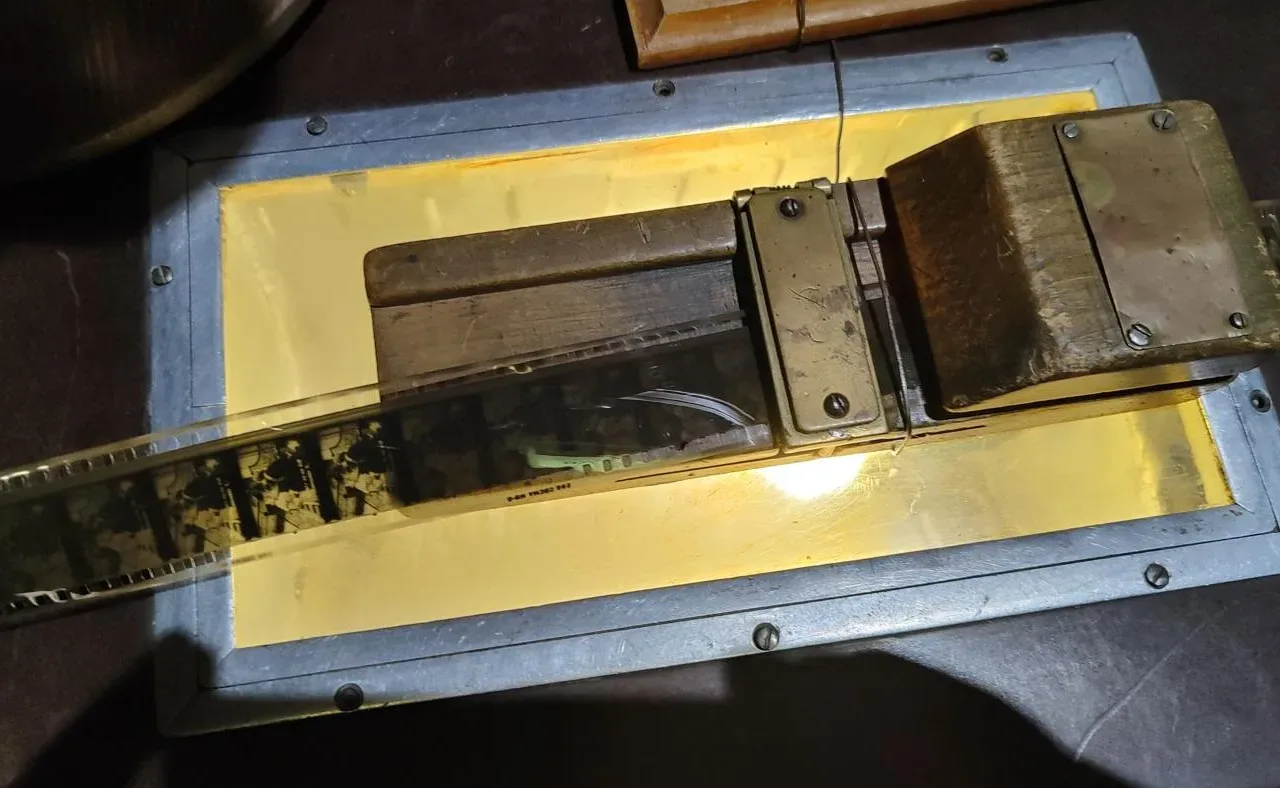 A strip of 35 mm film lies across an illuminated editing table.