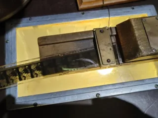 A strip of 35 mm film lies across an illuminated editing table.