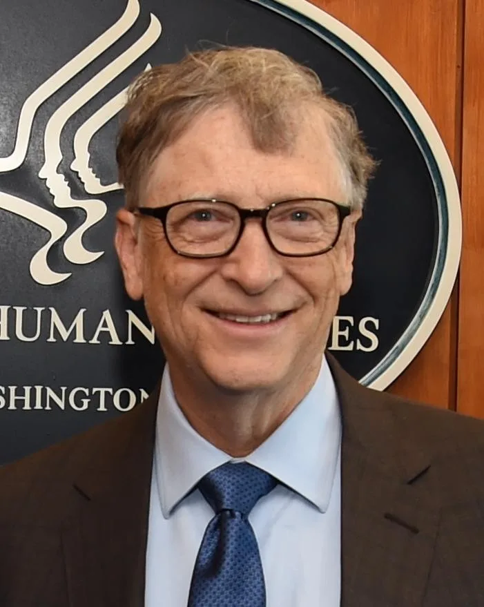 Bill Gates wearing glasses and a blue tie in a 2018 portrait