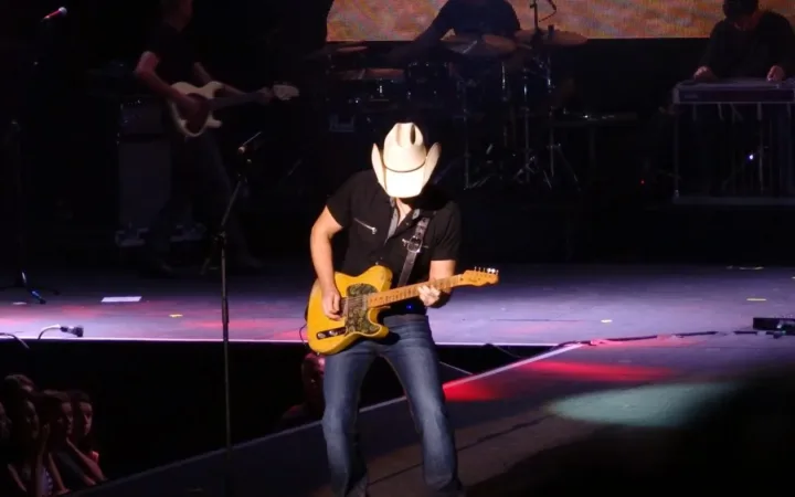 Brad Paisley wearing a cowboy hat and playing guitar onstage in Dublin