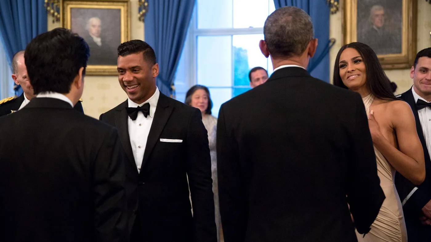 Open the featured image for Ciara and Russell Wilson: Ten Years of Shared Projects Russell Wilson at left and Ciara at right greet officials at the White House in April 2015