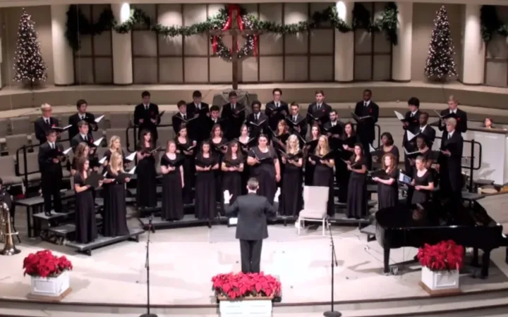 University of Arkansas Schola Cantorum choir sings together with a conductor in December 2012.