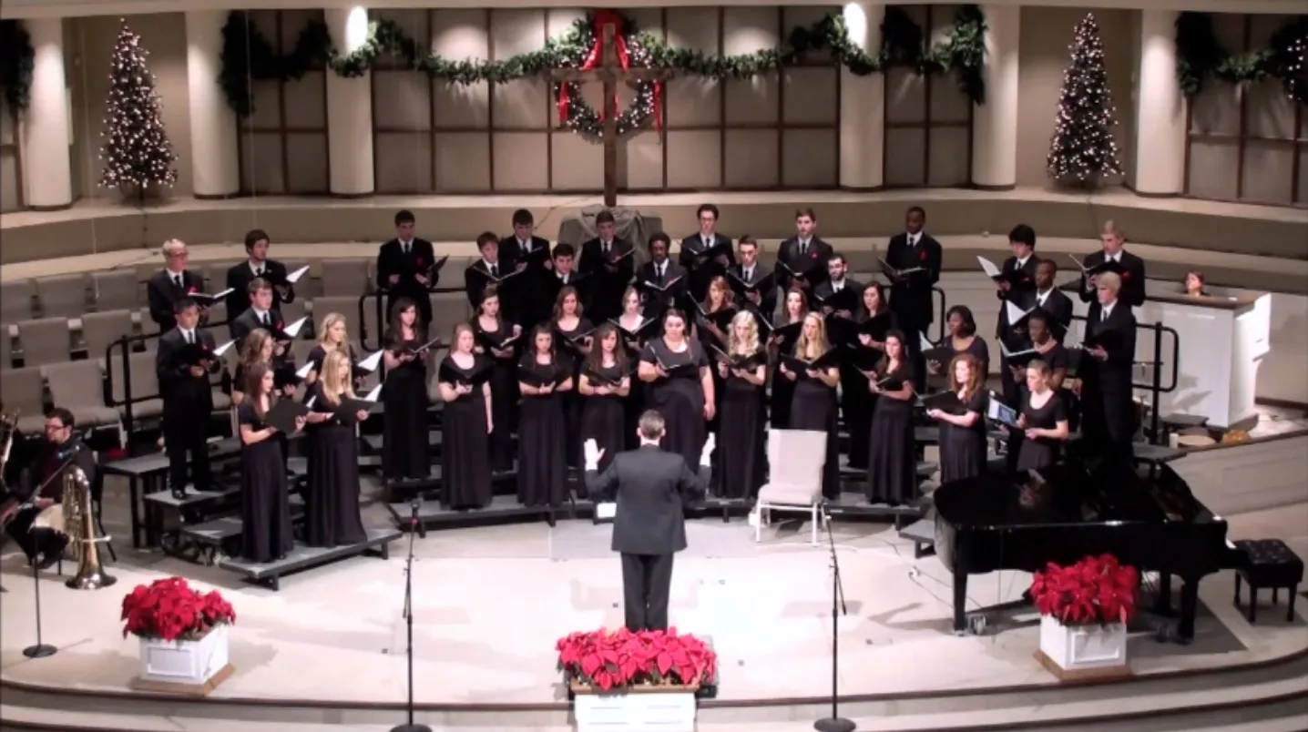 University of Arkansas Schola Cantorum choir sings together with a conductor in December 2012.