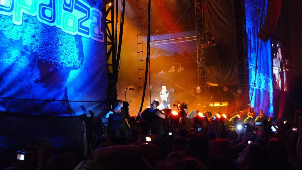 Eminem performing with his band on the Lollapalooza stage in 2011