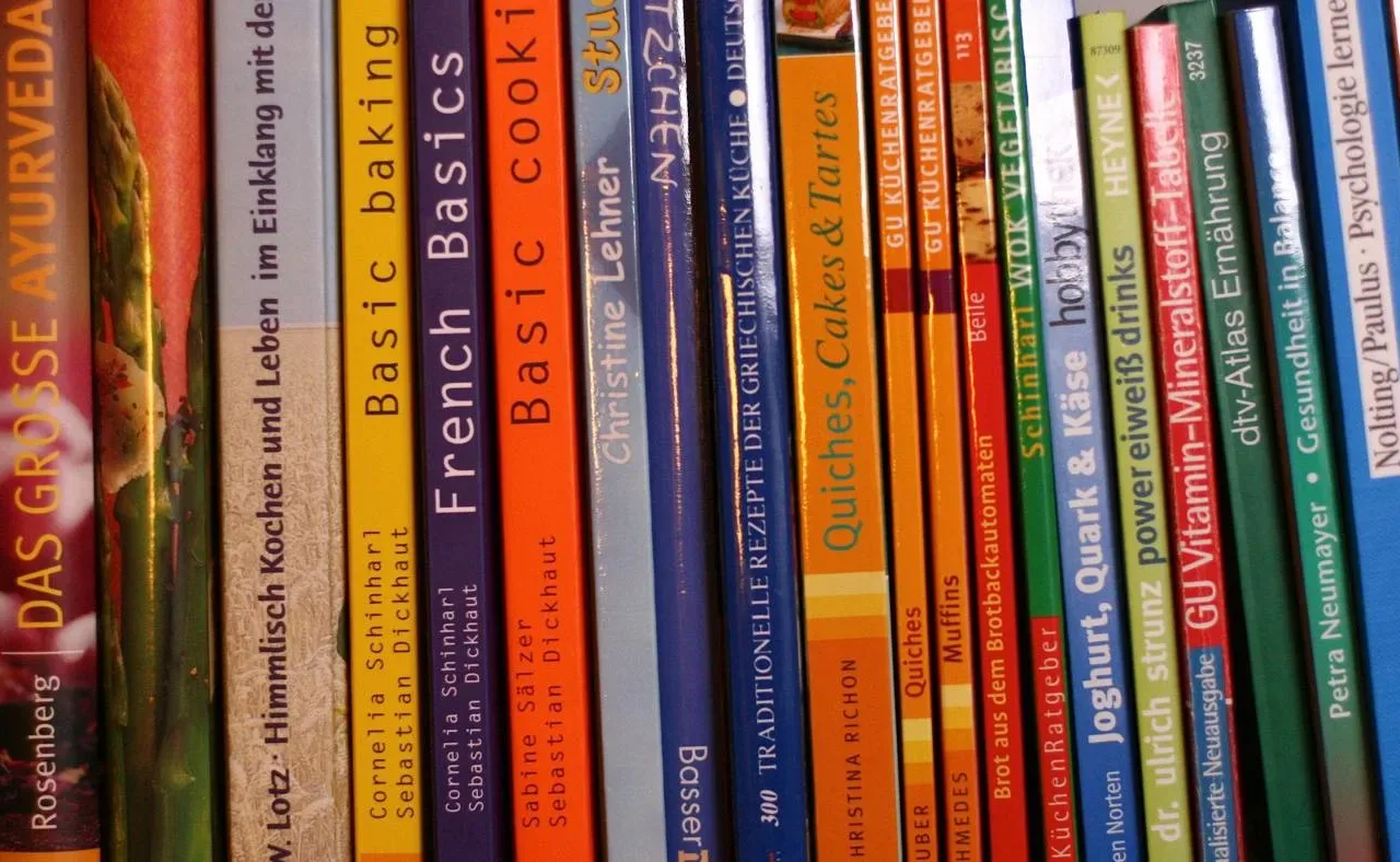 Cookbook spines on a shelf illustrating a family recipe collection