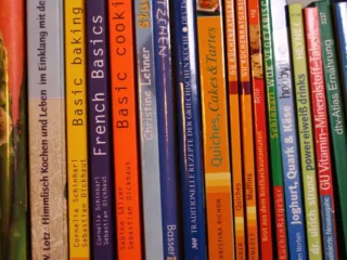 Cookbook spines on a shelf illustrating a family recipe collection