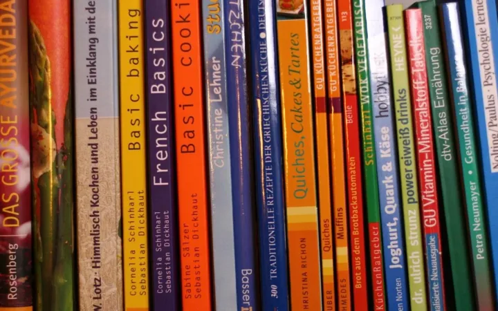 Cookbook spines on a shelf illustrating a family recipe collection