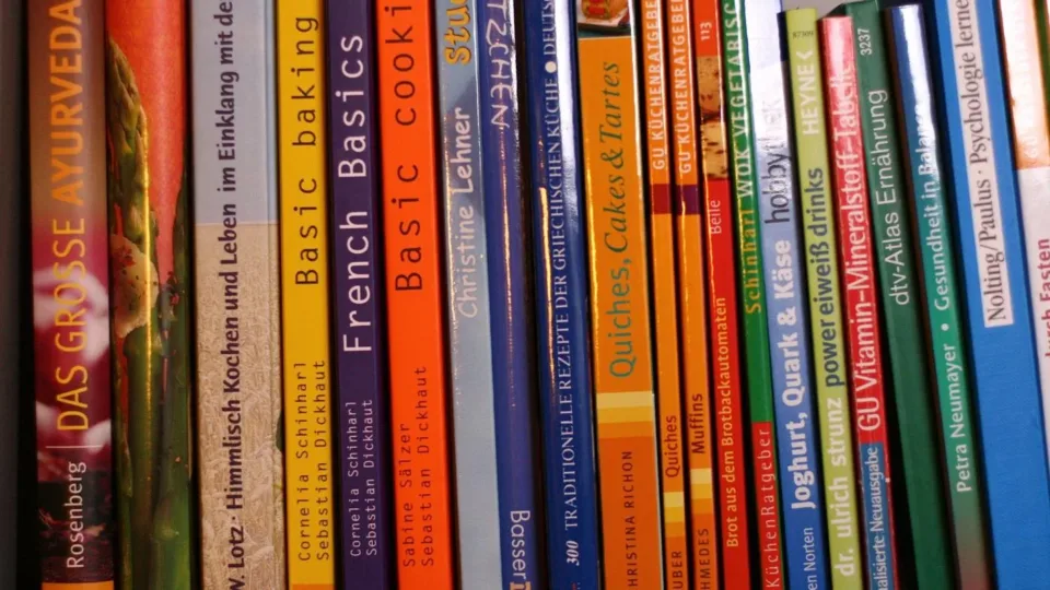 Cookbook spines on a shelf illustrating a family recipe collection