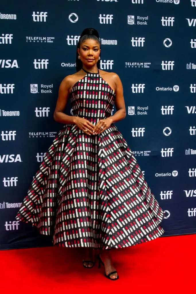 Gabrielle Union in a patterned dress in front of a Toronto International Film Festival backdrop