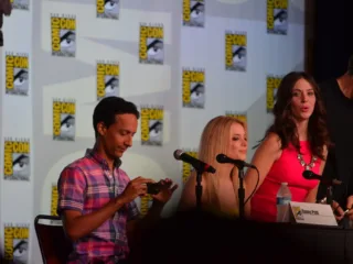 Gillian Jacobs in the centre with Danny Pudi on the left and Alison Brie on the right at a 2012 Comic-Con panel