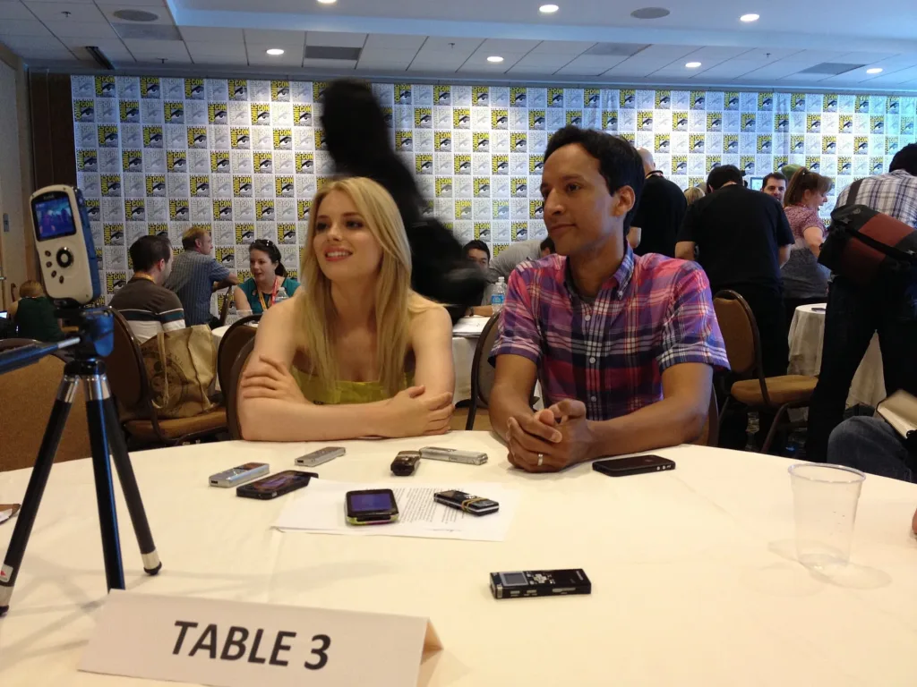 Gillian Jacobs seated on the left beside Danny Pudi during a Comic-Con press interview