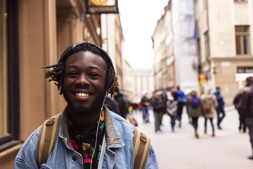 A man wearing earphones on a street in Stockholm