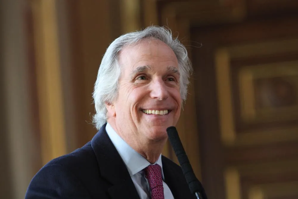 Henry Winkler at a microphone during a dyslexia event at the Foreign Office in London in 2013
