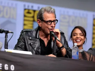 Jeff Goldblum speaking into a microphone on the Thor Ragnarok panel at San Diego Comic-Con in 2017