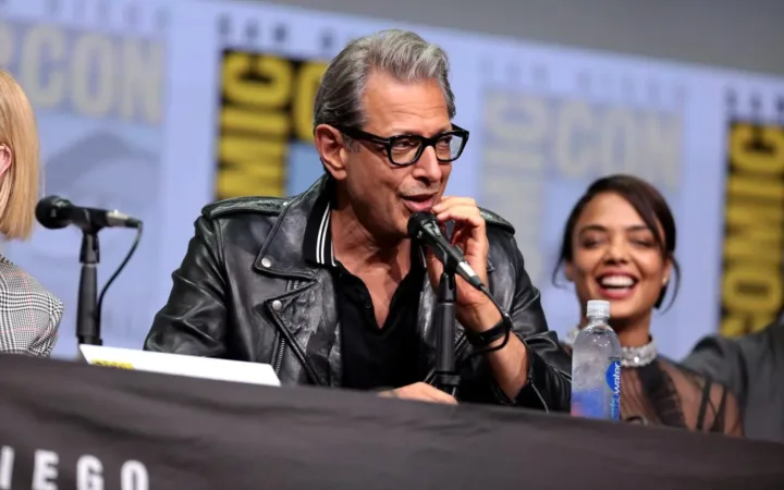 Jeff Goldblum speaking into a microphone on the Thor Ragnarok panel at San Diego Comic-Con in 2017