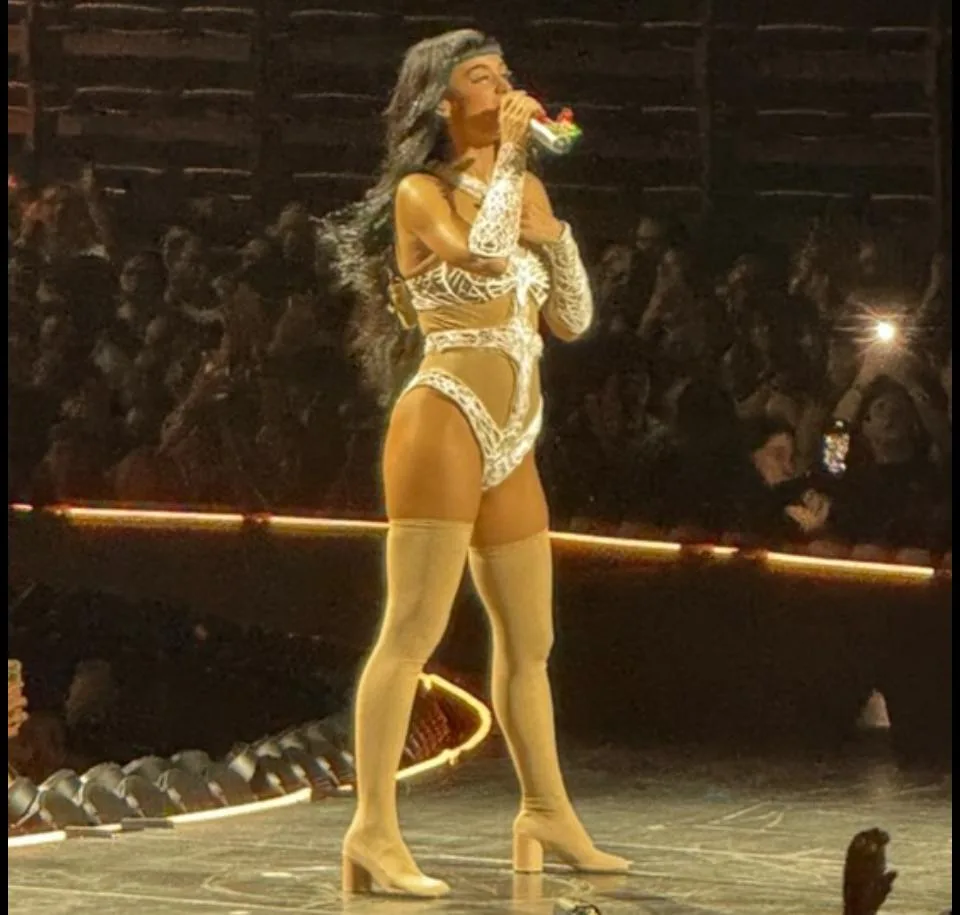 Katy Perry singing into a microphone at the MVM Dome in Budapest in October 2025