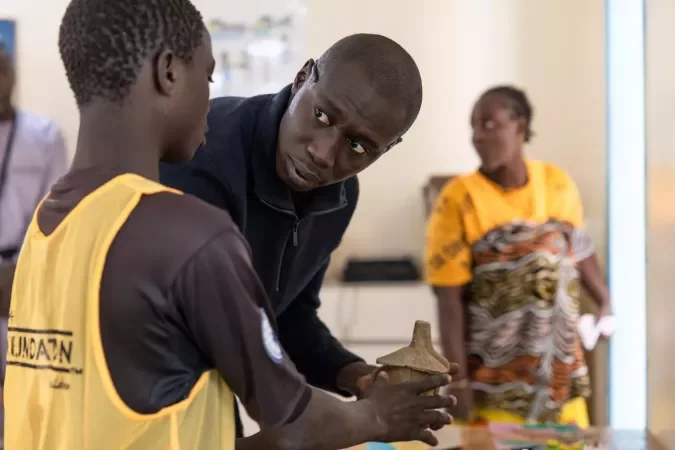 Khaby Lame listens to a young person during UNICEF's 2025 visit to the Samu Social shelter in Dakar.