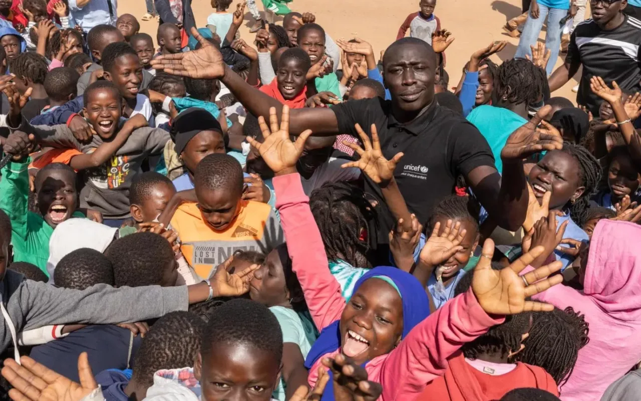 Khaby Lame stands with a group of young people during UNICEF's January 2025 visit to Senegal.