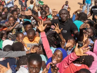 Khaby Lame stands with a group of young people during UNICEF's January 2025 visit to Senegal.