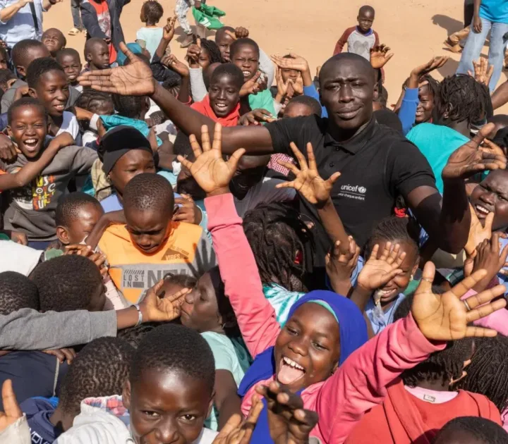 Khaby Lame stands with a group of young people during UNICEF's January 2025 visit to Senegal.