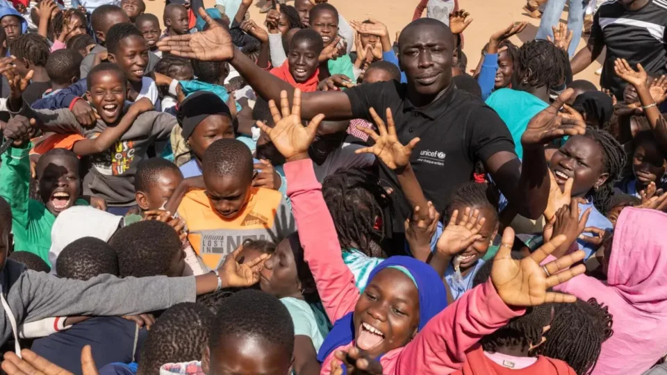 Khaby Lame stands with a group of young people during UNICEF's January 2025 visit to Senegal.