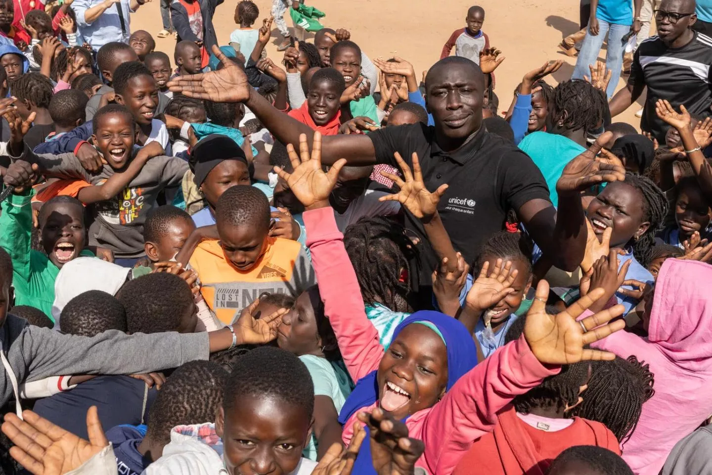 Khaby Lame stands with a group of young people during UNICEF's January 2025 visit to Senegal.