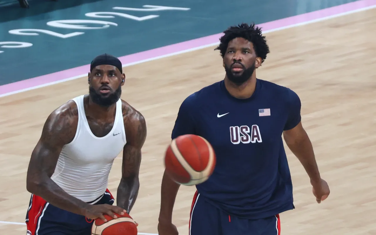 LeBron James and Joel Embiid warm up with basketballs at the Paris 2024 Olympics.