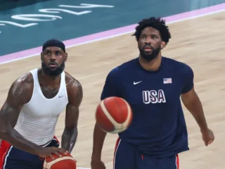 LeBron James and Joel Embiid warm up with basketballs at the Paris 2024 Olympics.