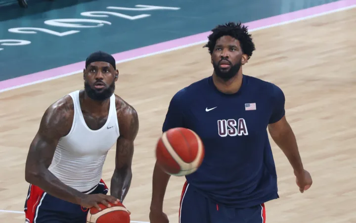 LeBron James and Joel Embiid warm up with basketballs at the Paris 2024 Olympics.